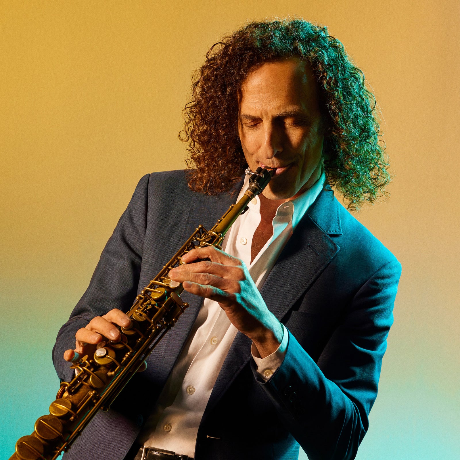 Photo of Kenny G playing his instrument against a yellow and teal gradient background